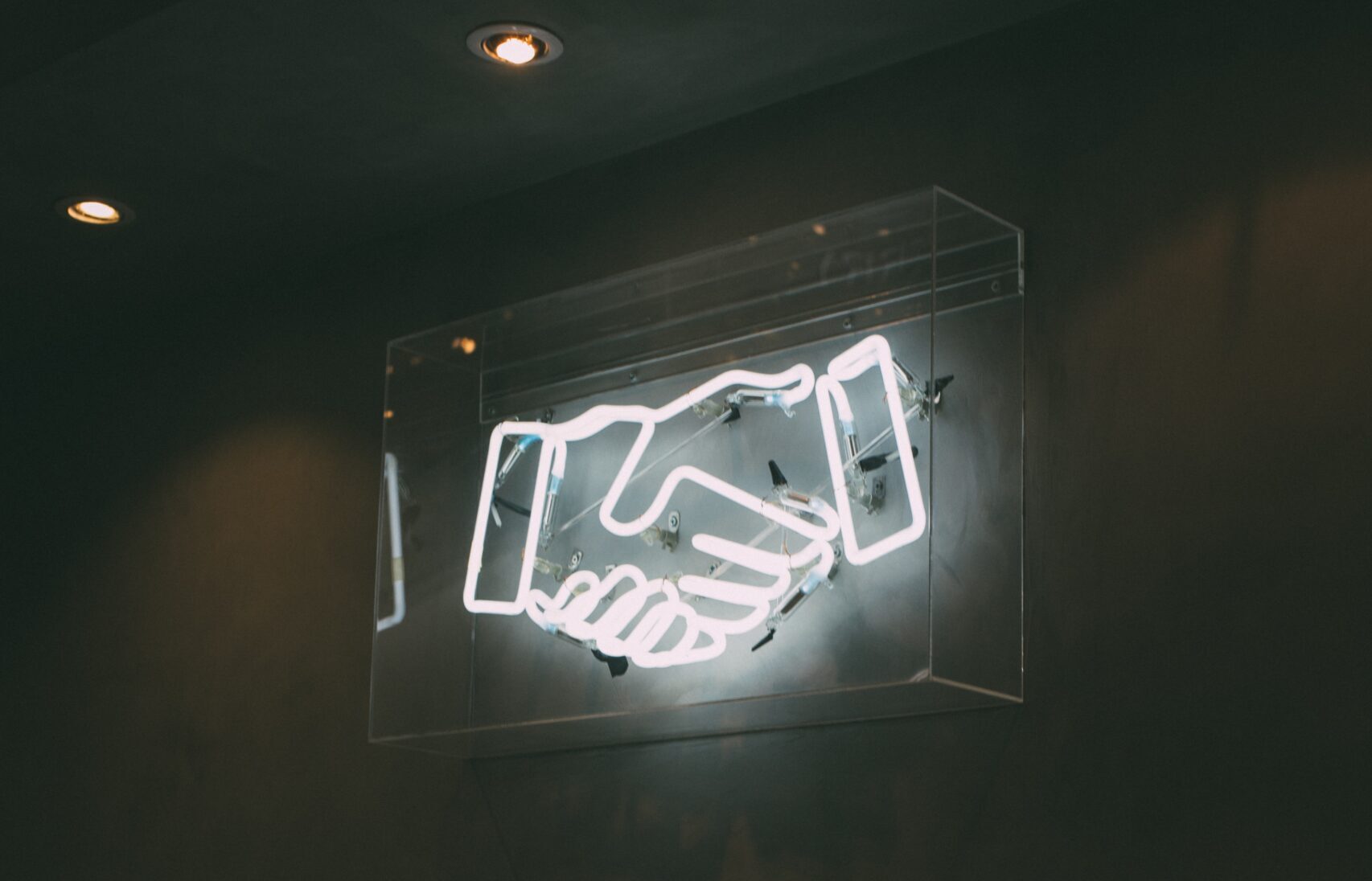 Handshake on a neon sign