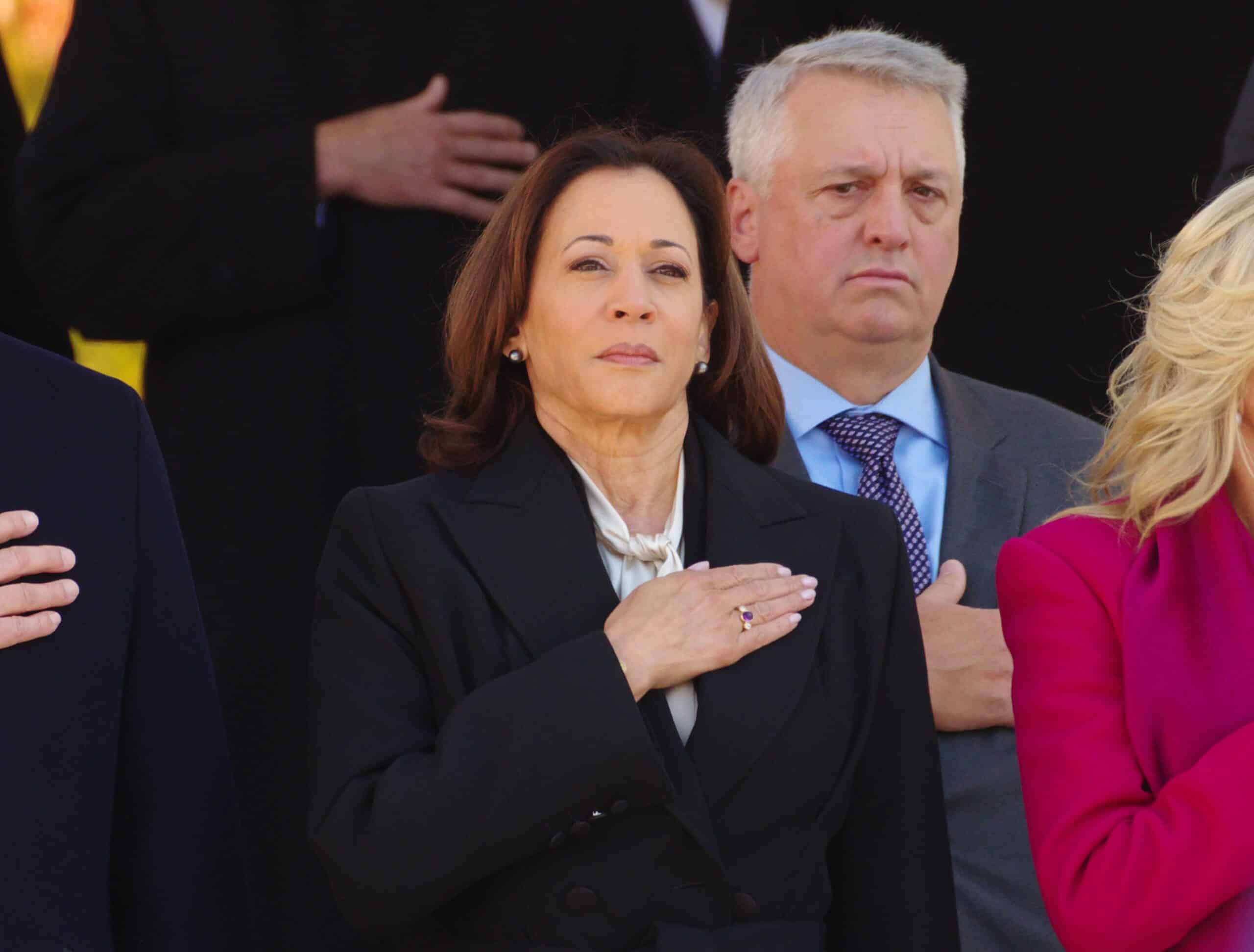 ARLINGTON, VA, USA - November 11, 2023: U.S. Vice President Kamala Harris stands at attention in all places in the having fun with of the national anthem at a Veterans Day ceremony at Arlington National Cemetery.