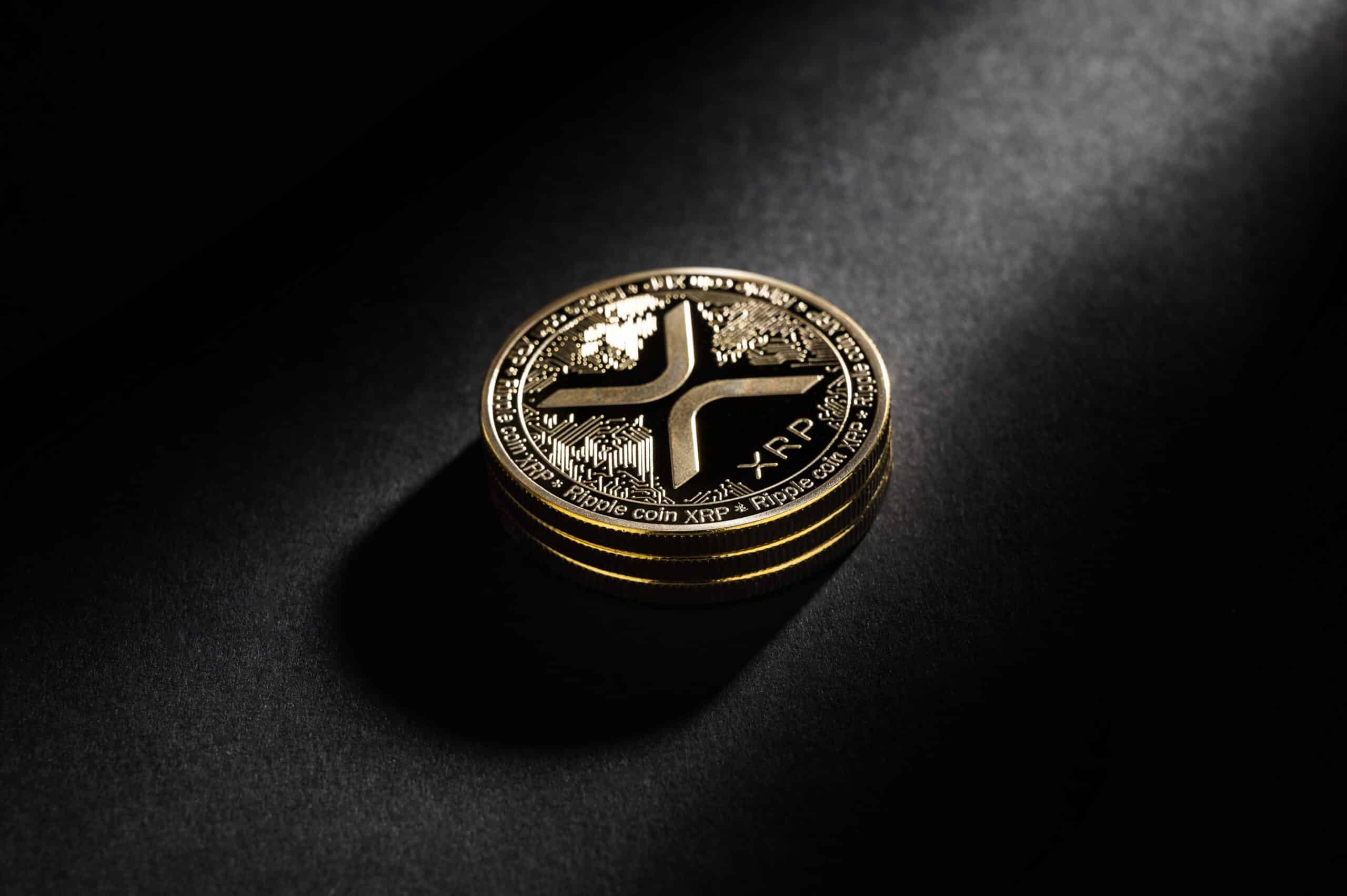 XRP coin over a black background (Shutterstock)